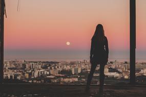 girl looking at Architecture city at sunset