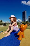 modern child girl and teddy bear Sculpture in city