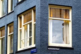 Beautiful, dark house with the windows with reflections, in Amsterdam, Netherlands