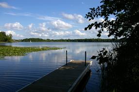 summer lake with a wooden bridge