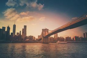 Coast of the city, with the bridge, at colorful sunset with clouds