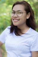 portrait of a young girl with glasses on a blurred background