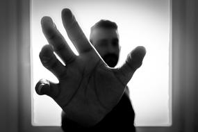 monochrome photo of a man with an outstretched arm