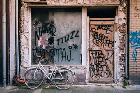 Retro bike near the old building with colorful graffities