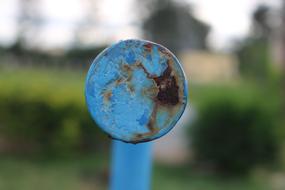 a rusty blue piece of iron