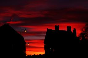 european houses on the background of red-orange sunset