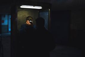 photographer Inside Dark Door