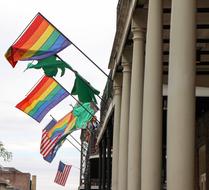Colorful flags of LGBT and USA, on the building with columns, in USA