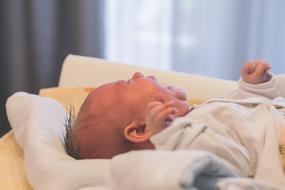 Cute and screaming, laying child
