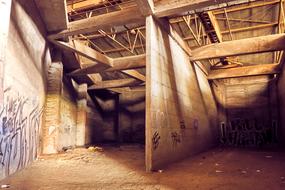 Interior of the building with graffities, in light and shadows