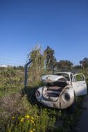 old broken down car in the field