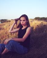 girl with long hair posing in the meadow