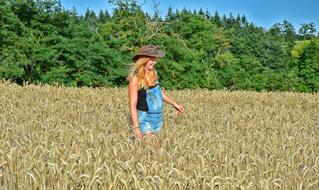 Beautiful Girl dry grass and green trees