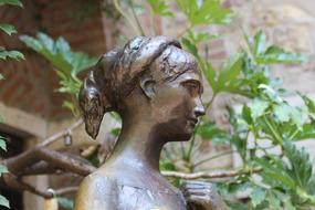 bronze statue of a girl in the park