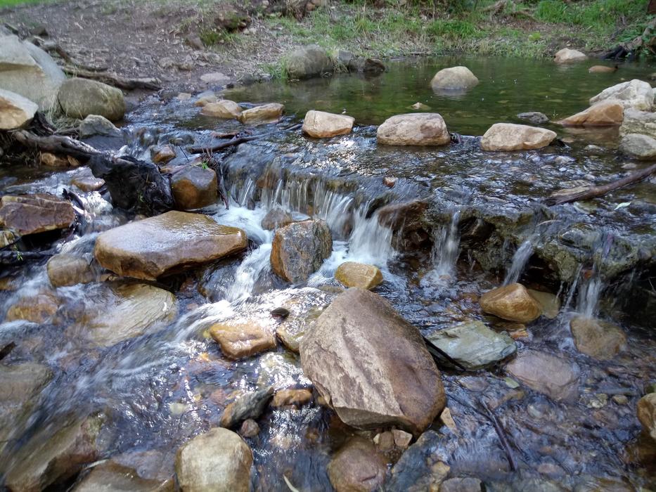 river with stones at the house