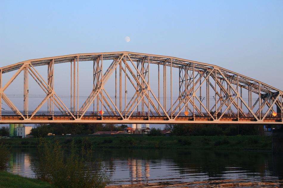 Bridge above the water in KrakÃ³w, Poland, at colorful and beautiful sunset
