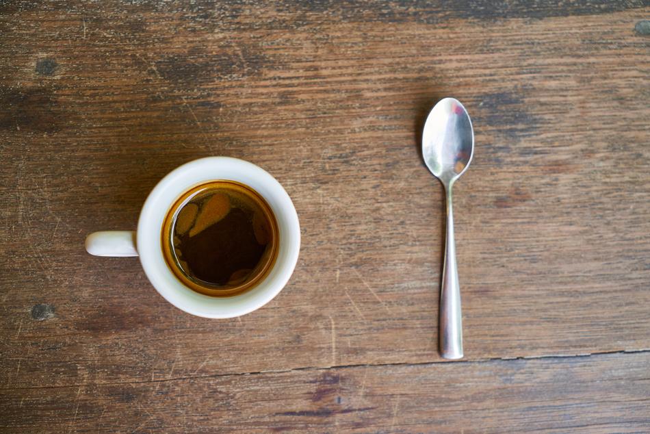 sweet coffee on the table with a spoon