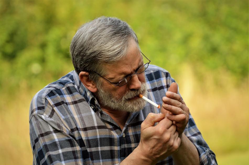 adult man with a cigarette on a blurred background