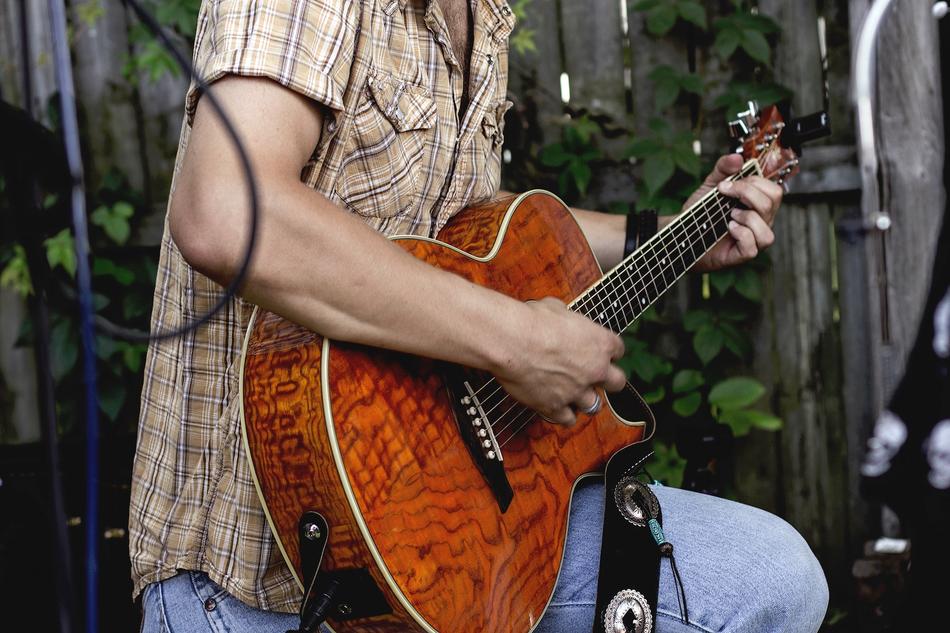 guy with a guitar on the street close up
