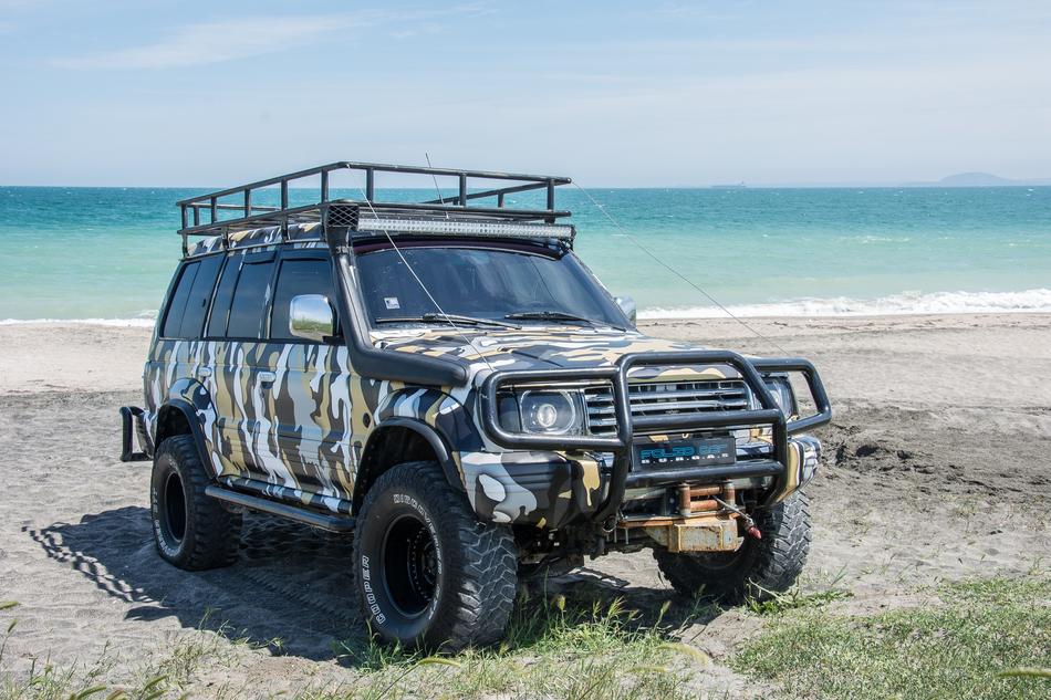 a big car by the ocean