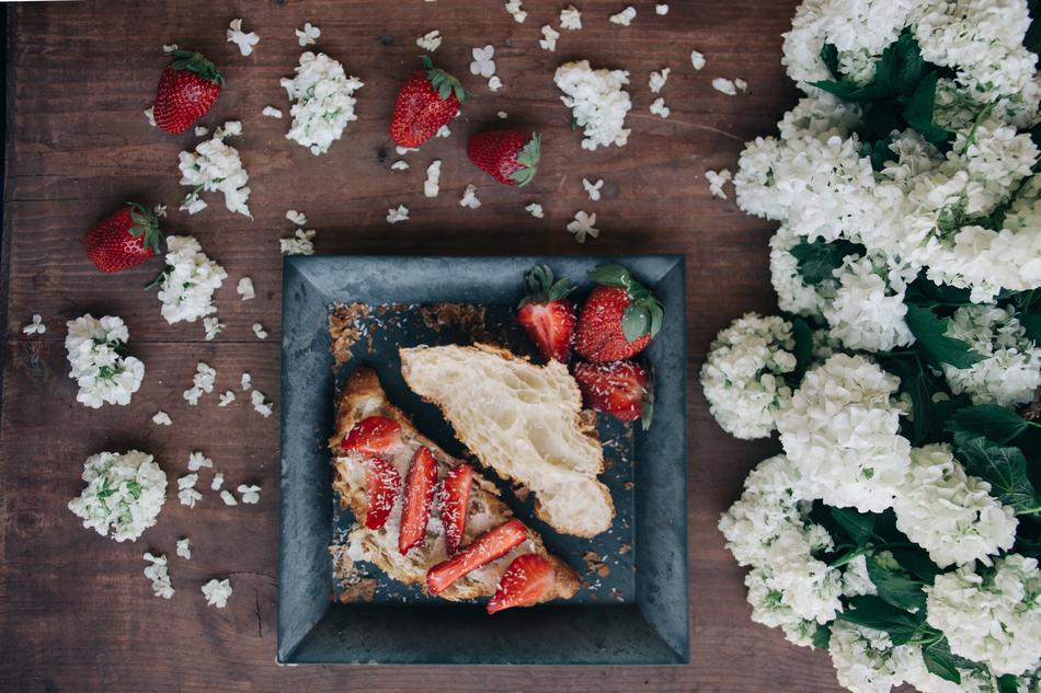 delicious breakfast with strawberries on white flowers