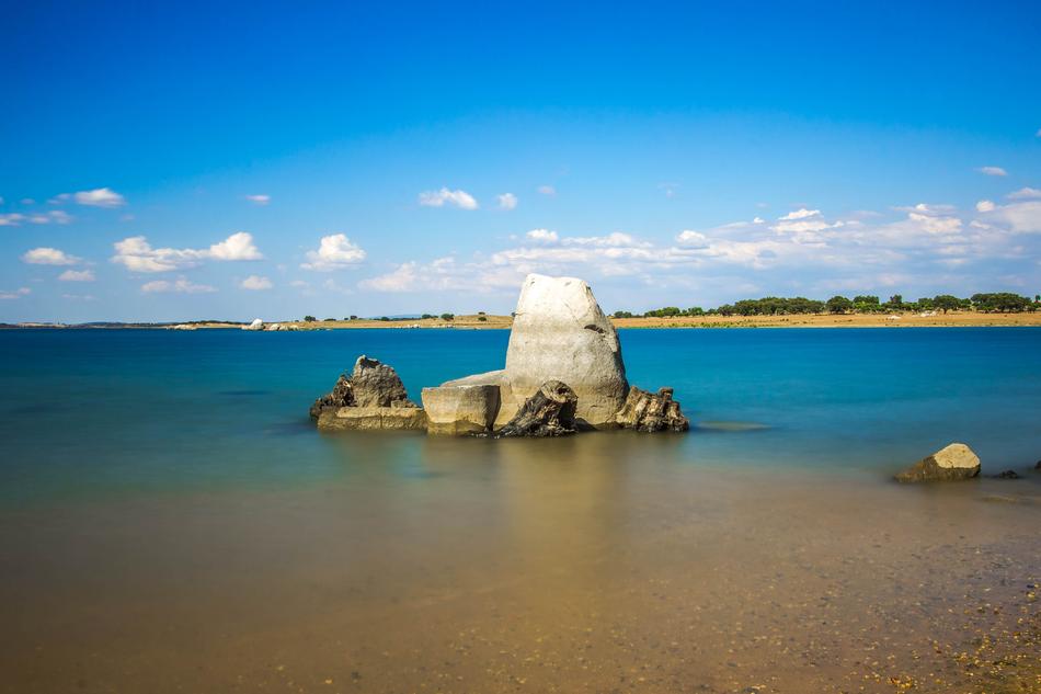 stone wall in a sandy sea