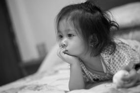 little pensive girl in a blurred background