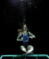 the girl underwater with the balloon