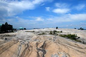 People, on the beautiful top of the stone mountain with plants