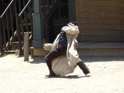 a photo of a falling cowboy in the wild west
