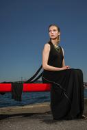 woman in a black dress by the sea