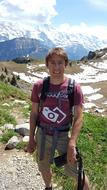 Smiling man on the beautiful mountains with snow in Switzerland