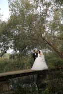 a beautiful couple at a wedding in the park