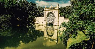 white gate by the green river