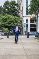 a man in a business suit runs down the street