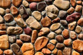 Texture of the stone wall with the colorful stones