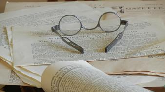 ancient glasses on old newspapers