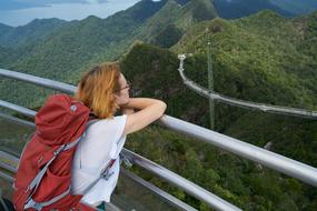 young girl with a red backpack on the observation deck