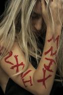 photo of a blonde with a red lettering on her hand