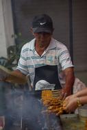 man in the cap is cooking
