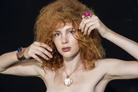 the redheaded girl is beautiful with the jewelry