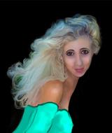 portrait of a blonde in a green dress