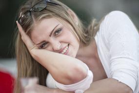 beautiful smiling girl in a relaxed pose on a blurred background