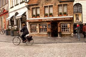 man on bicycle outside a store