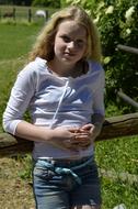 blonde with long hair in the garden on a sunny day