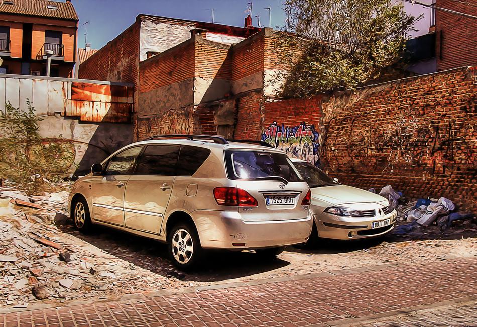 parked cars against the wall with graffiti in Madrid