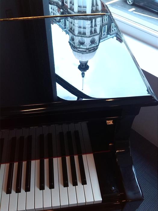 reflection of the building on the piano
