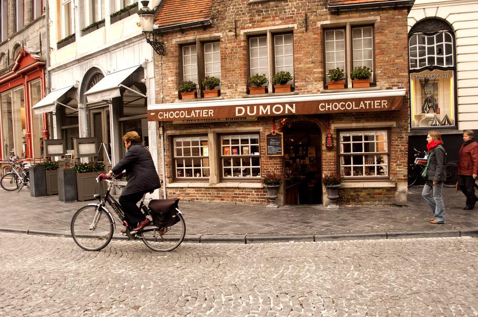 man on bicycle outside a store