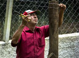 portrait of a farmer is making a wire fence