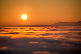 baking sun in a cloudy sky
